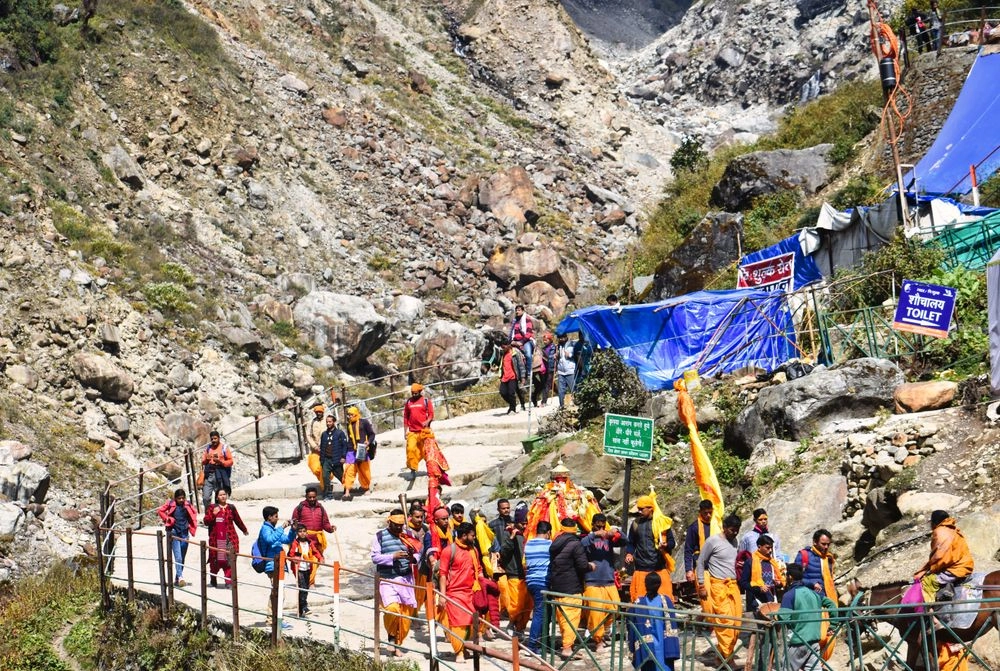 Pilgrims walking the rocky Kedarnath trail through the Himalayas