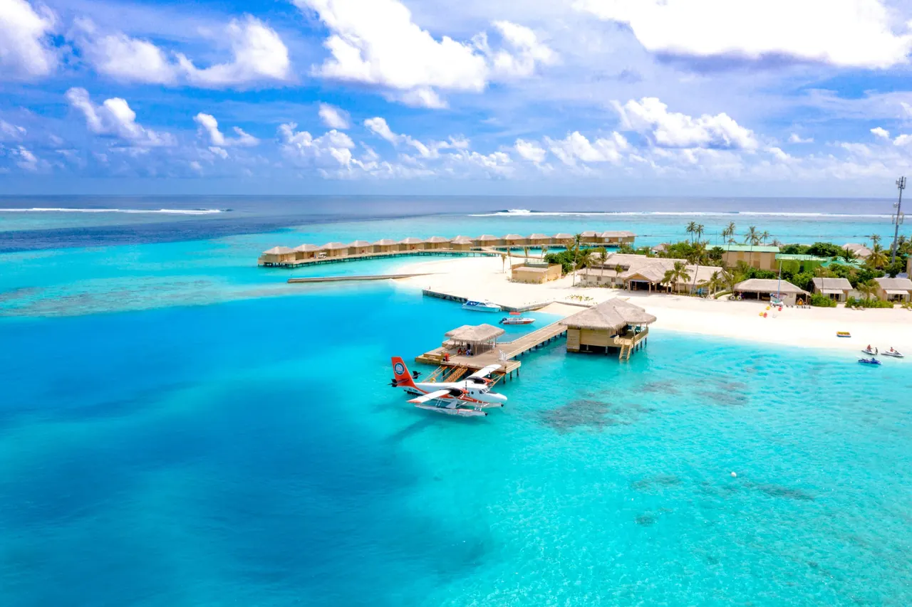 Overwater villas on stilts above a turquoise lagoon in the Maldives