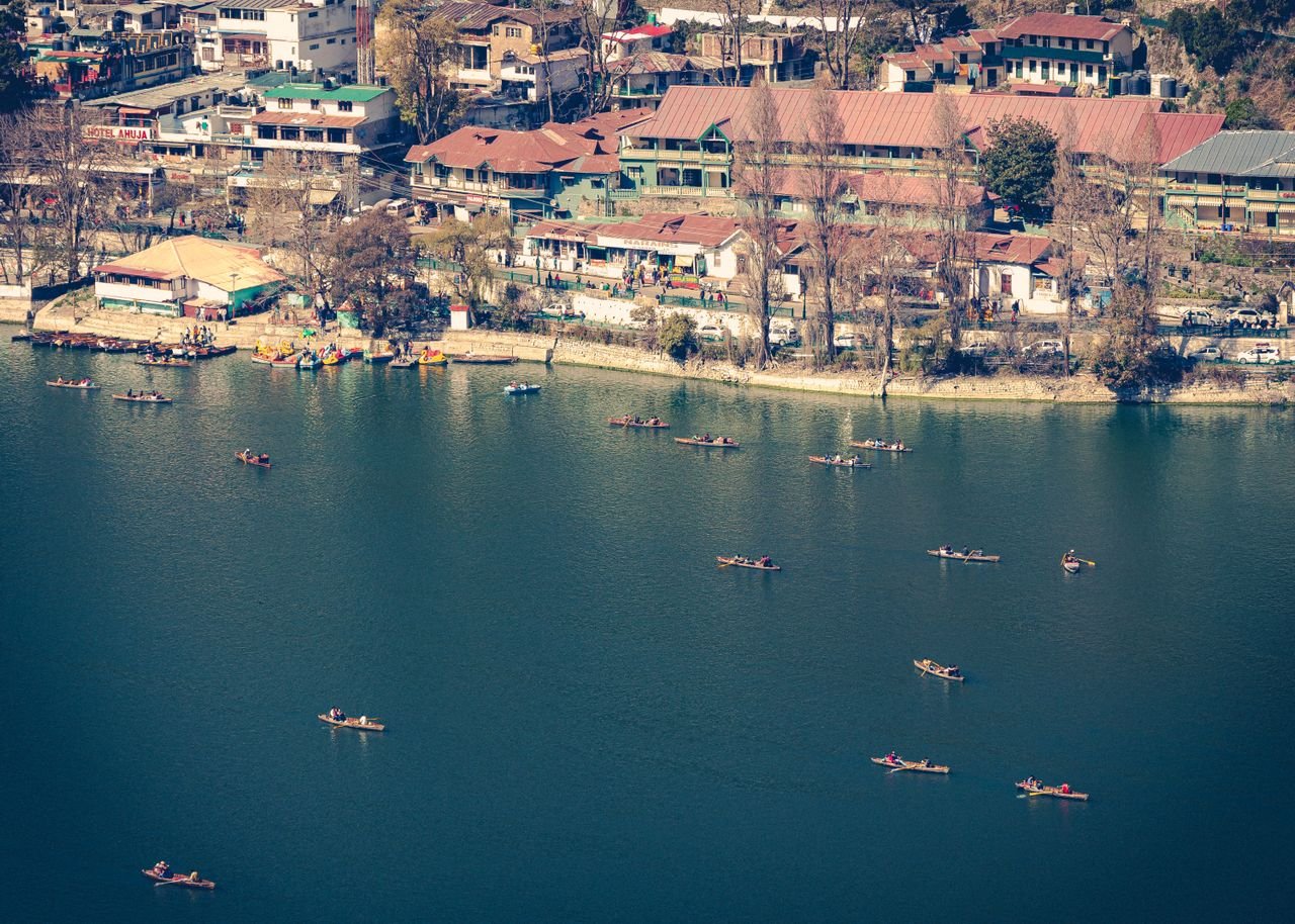 Naini Lake in Nainital surrounded by forested hills